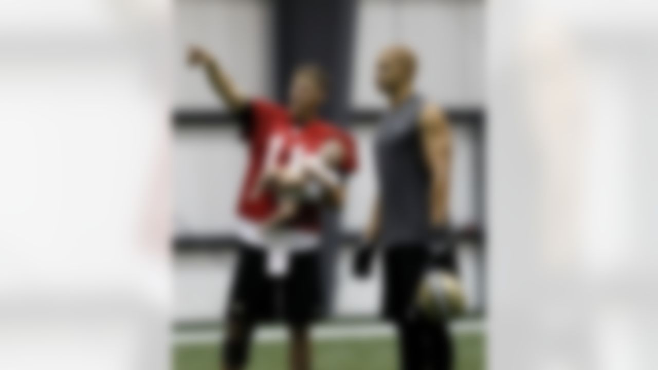 New Orleans Saints quarterback Luke McCown (11) holds his son Isaiah McCown as he talks with tight end Jimmy Graham after training camp practice at their indoor NFL football training facility in Metairie, La., Friday, July 27, 2012. (AP Photo/Gerald Herbert)