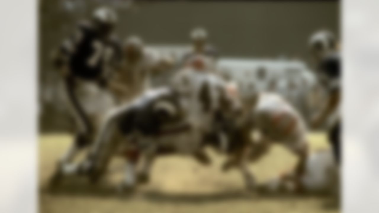 Los Angeles Rams defensive tackles Coy Bacon (79) and Hall-of-Famer Merlin Olsen (74) sandwich Atlanta Falcons running back Dave Hampton (43) during a 20-7 Rams victory on November 5, 1972, at the Los Angeles Memorial Coliseum in Los Angeles, California. (AP Photo/NFL Photos)