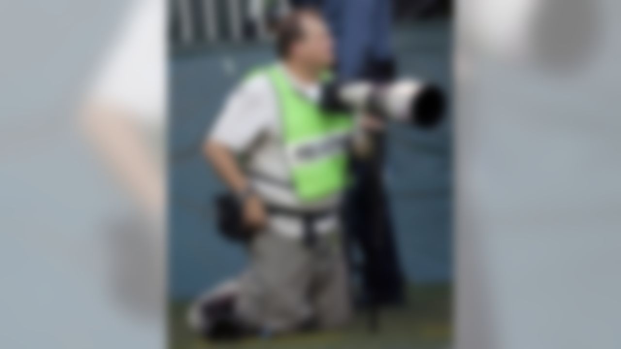 Actor Drew Carey photographs the New York Jets' 17-7 win over the Miami Dolphins, Sunday, Sept. 18, 2005, at Giants Stadium in East Rutherford, N.J. (AP Photo/Bill Kostroun)