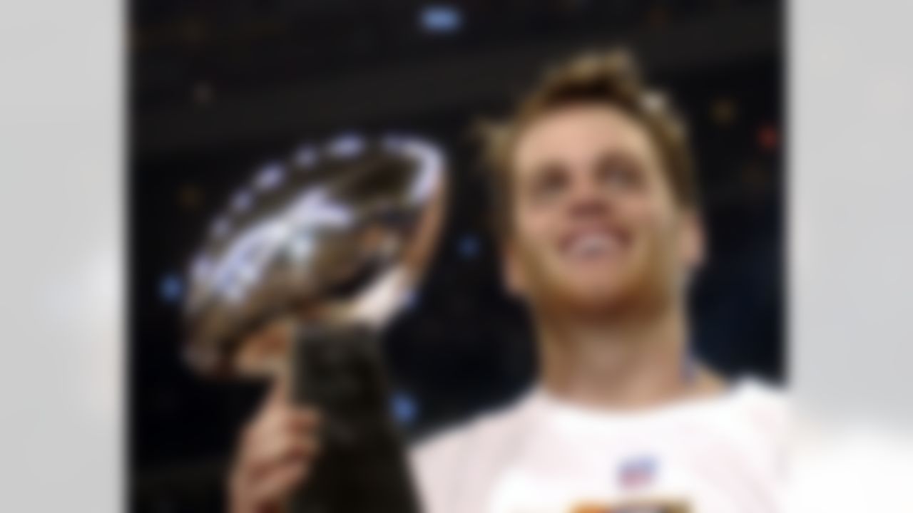 New England Patriots quarterback Tom Brady (12) holds the Vince Lombardi Trophy after the Patriots beat the Carolina Panthers 32-29 in Super Bowl XXXVIII at the Reliant Stadium in Houston, TX Sunday Feb. 1, 2004. (AP Photo/Dave Martin)