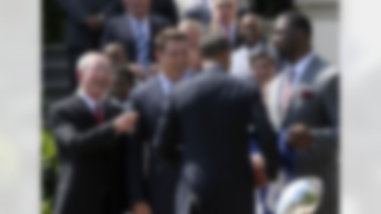 President Barack Obama talks with members of the New York football Giants, from left, head coach Tom Coughlin, and captians Zak DeOssie, and Justin Tuck, on the South Lawn at the White House in Washington, Friday, June 8, 2012, during a ceremony where the president honored the Super Bowl XLVI Champions. (AP Photo/Susan Walsh)