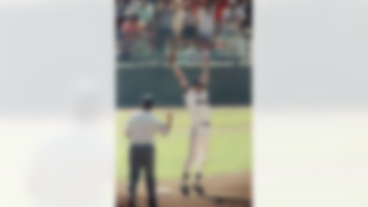 San Francisco Giants Will Clark leaps in joy as first base umpire Randy Marsh signals the final out of the National League Playoffs, Monday, Oct. 9, 1989, San Francisco, Calif. The Giants beat the Cubs 3-2 to capture the series in five games and advance to the World Series. (AP Photo/John Gaps)