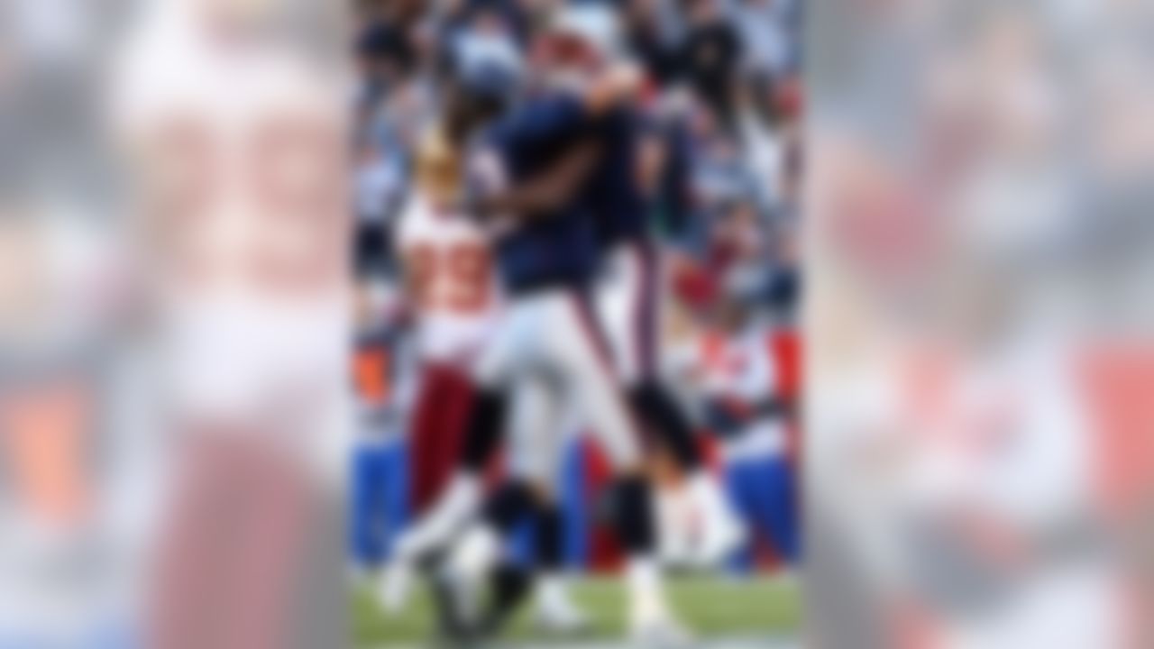 FOXBORO, MA - OCTOBER 28: Randy Moss #81 of the New England Patriots congratulates Tom Brady #12 after Brady ran the ball in for a touchdown in the first quarter against the Washington Redskins at Gillette Stadium October 28, 2007 in Foxboro, Massachusetts. (Photo by Elsa/Getty Images)