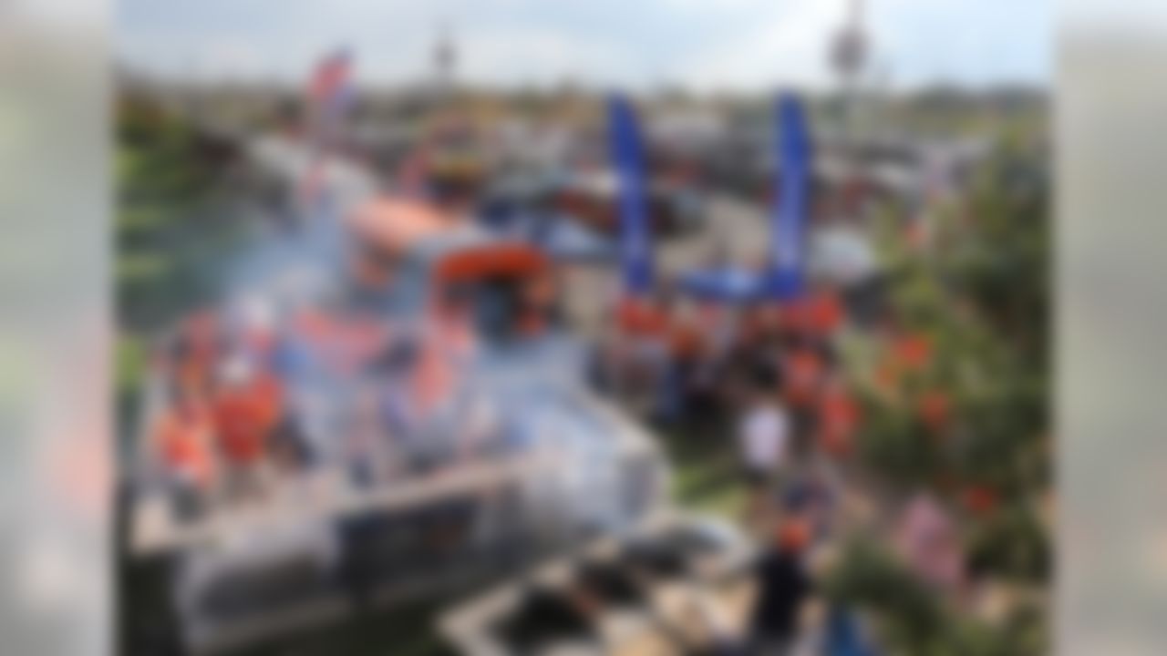 Fans tailgate outside the stadium prior to an NFL football game between the Denver Broncos and the Baltimore Ravens, Thursday, Sept. 5, 2013, in Denver. (AP Photo/Brennan Linsley)