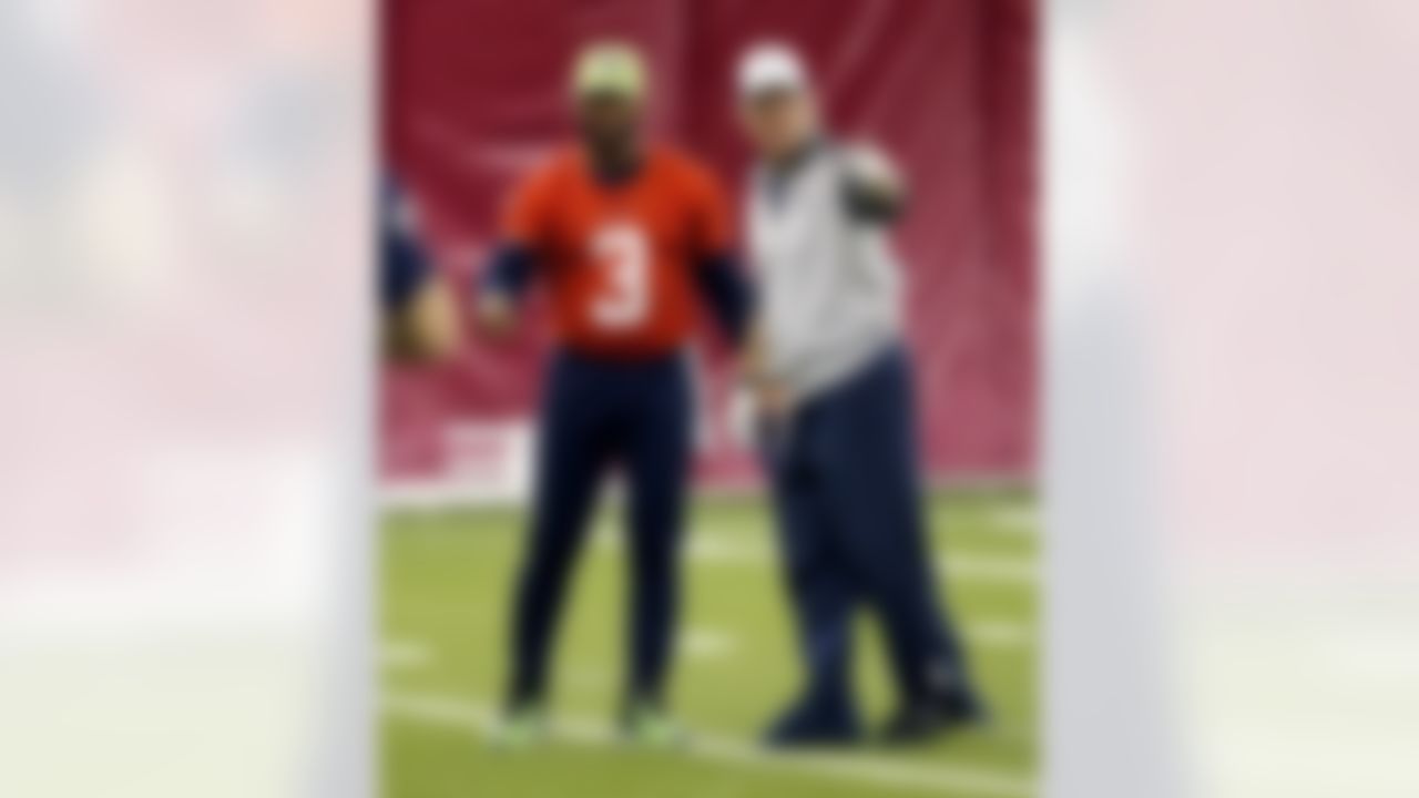 Seattle Seahawks' Russell Wilson (3) talks with quarterback coach Carl Smith during a team practice for NFL Super Bowl XLIX football game, Friday, Jan. 30, 2015, in Tempe, Ariz. The Seahawks play the New England Patriots in Super Bowl XLIX on Sunday, Feb. 1, 2015. (AP Photo/Matt York)
