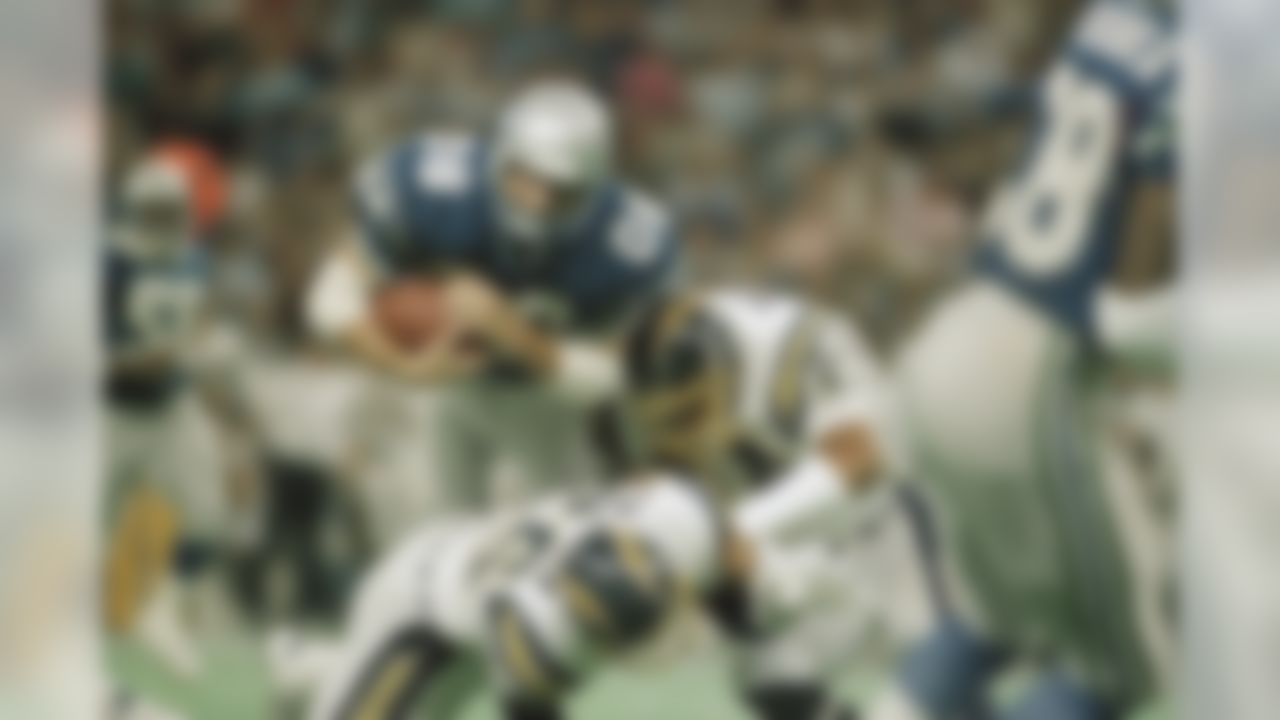 Seattle Seahawks receiver Steve Largent (80) is tackled by San Diego Charger defenders Martin Bayless (44) and Danny Walters (23) during first quarter action in the Kingdome on Nov. 22, 1987 in Seattle. Largent gained 29 yards on the pass play. (AP Photo/Barry Sweet)
