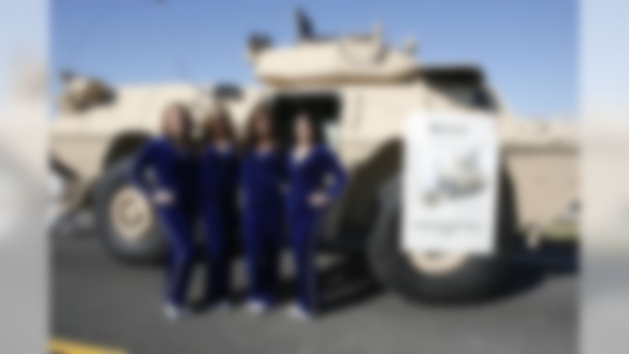 Feb 2, 2012; Edinburgh, IN, USA; Indianapolis Colts cheerleaders pose in front of a M1117 armored security vehicle during the NFL players visit to Camp Atterbury. Mandatory Credit: Brian Spurlock-US PRESSWIRE