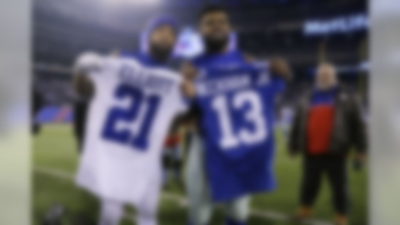 Dallas Cowboys running back Ezekiel Elliott (21) and New York Giants wide receiver Odell Beckham (13) exchange jerseys after an NFL football game Sunday, Dec. 11, 2016, in East Rutherford, N.J. The Giants won 10-7. (AP Photo/Seth Wenig)