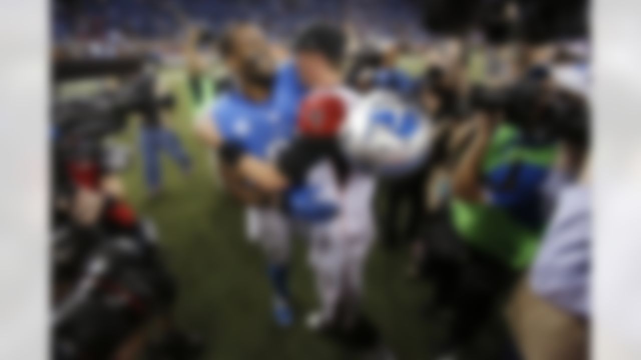 Detroit Lions wide receiver Calvin Johnson hugs Atlanta Falcons quarterback Matt Ryan (2) after an NFL football game at Ford Field in Detroit, Saturday, Dec. 22, 2012. Johnson broke the single-season record for receiving yards. (AP Photo/Duane Burleson)