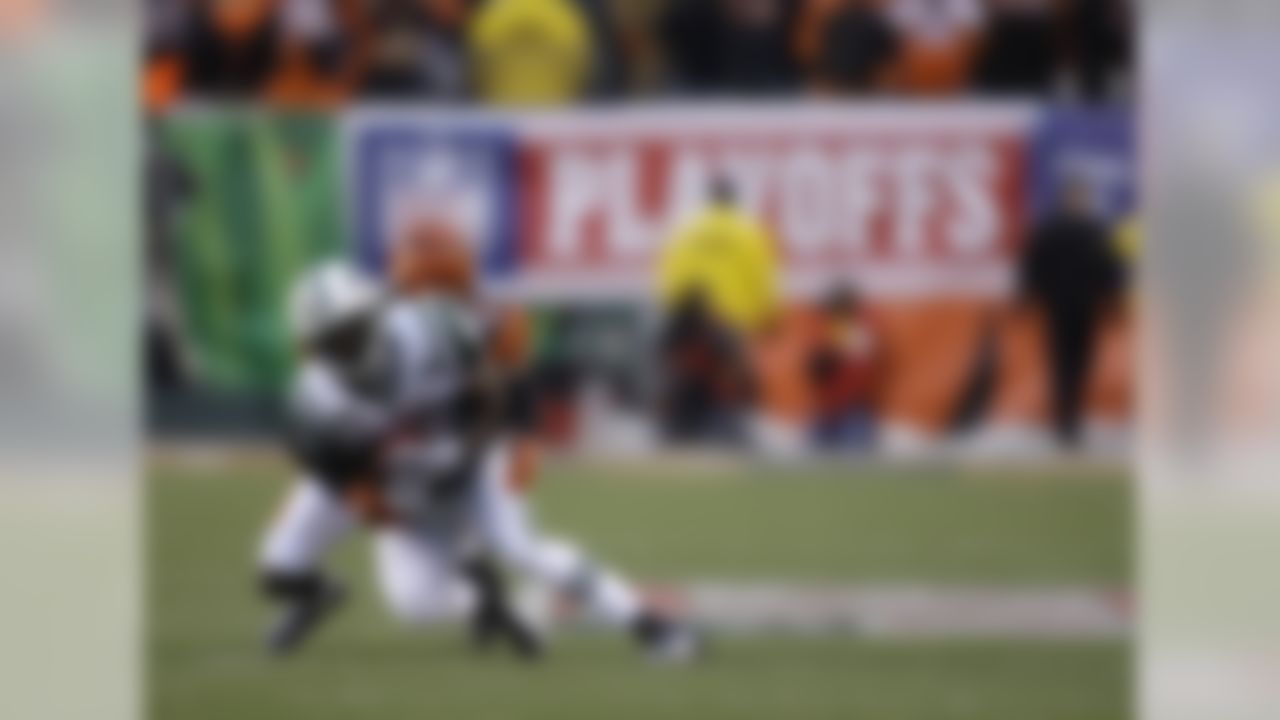 New York Jets wide receiver Jerricho Cotchery is tackled by Cincinnati Bengals cornerback Johnathan Joseph during the first half of an NFL wild-card playoff football game, Saturday, Jan. 9, 2010, in Cincinnati. (AP Photo/Rob Carr)