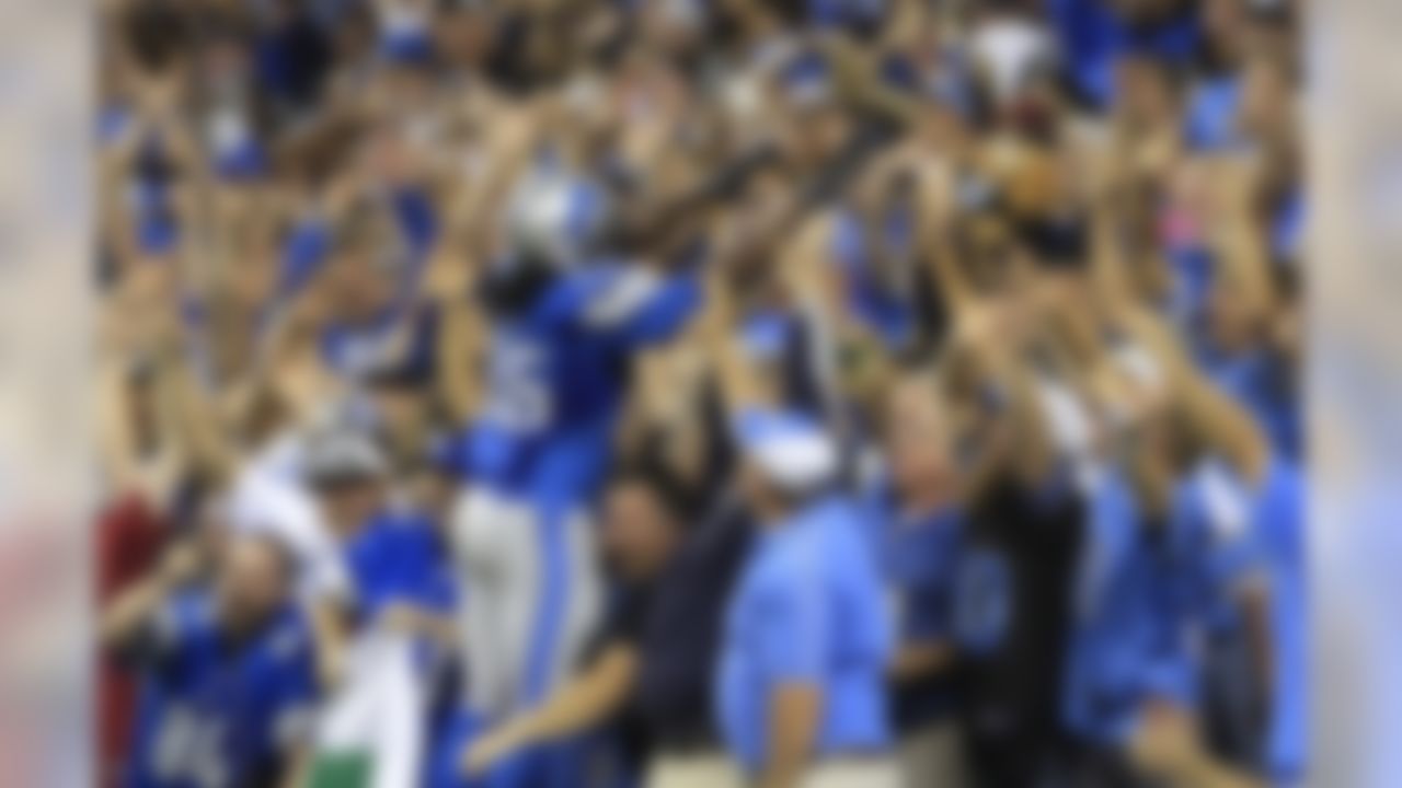 Detroit Lions running back Joique Bell celebrates with fans after scoring during the fourth quarter of an NFL football game against the New York Giants in Detroit, Monday, Sept. 8, 2014. (AP Photo/Bill Fundaro)