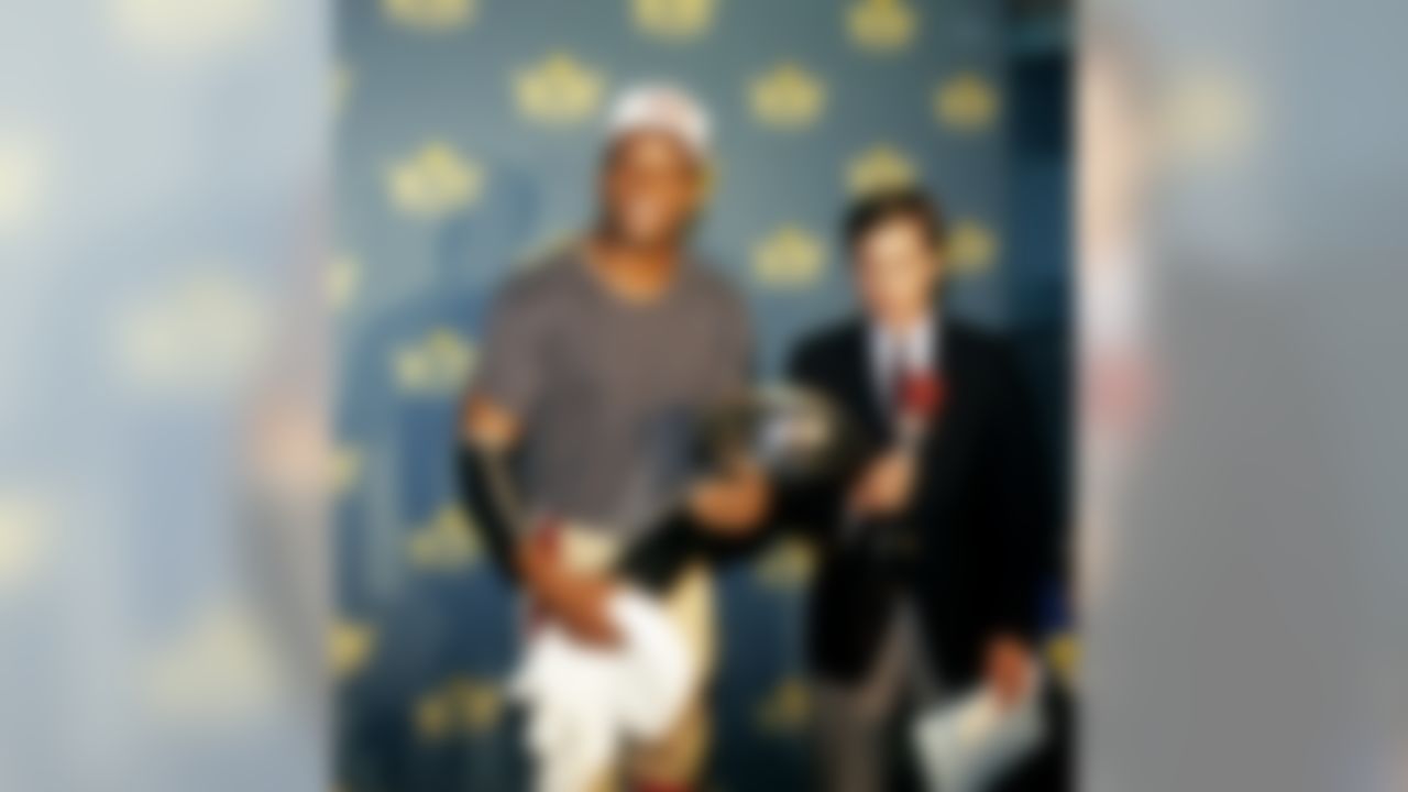 Hall of Fame defensive back Ronnie Lott of the San Francisco 49ers holds the Vince Lombardi Trophy in the locker room while waiting to be interviewed by NBC's Bob Costas following the 49ers 20-16 victory over the Cincinnati Bengals in Super Bowl XXIII on January 22, 1989 at Joe Robbie Stadium in Miami, Florida. (National Football League)