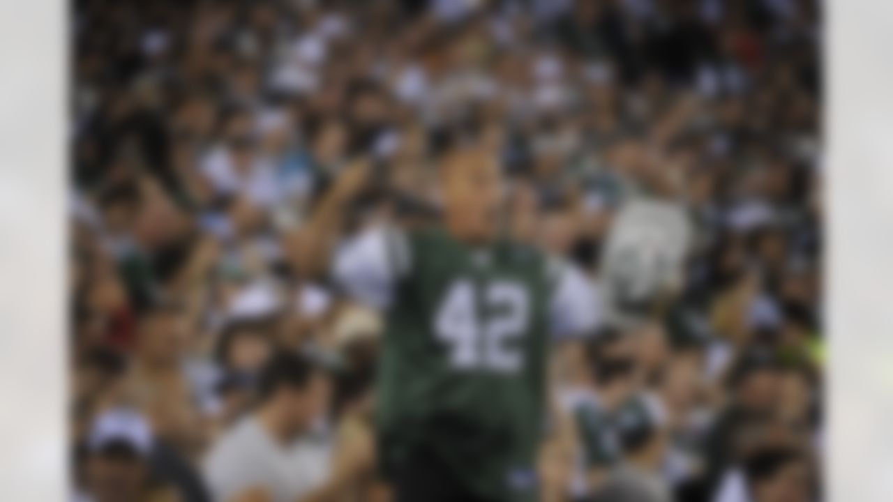New York Jets fan "Fireman Ed" cheers during the third quarter of an NFL football between the New York Jets and the Baltimore Ravens at New Meadowlands Stadium in East Rutherford, N.J., Monday, Sept. 13, 2010. (AP Photo/Bill Kostroun)