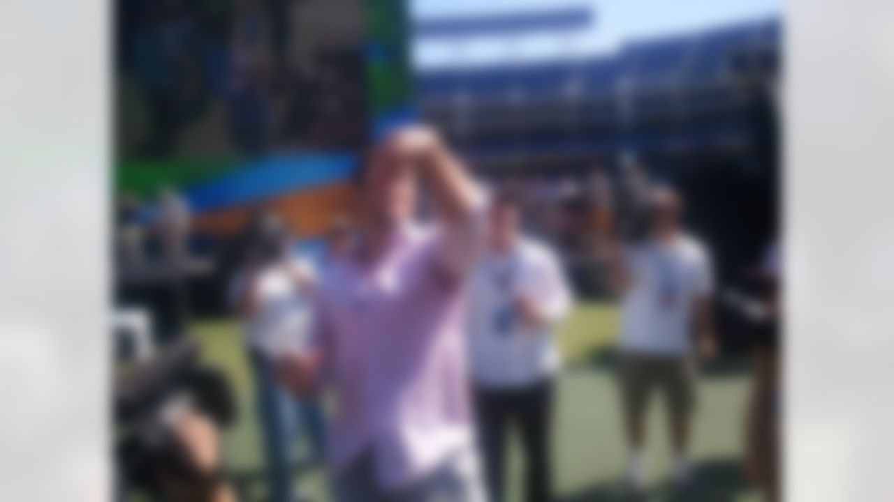 New York Jets quarterback Tim Tebow tosses footballs to fans before delivering a sermon at Qualcomm Stadium in San Diego, California on June 17, 2012. (Kenny Legan/NFL)