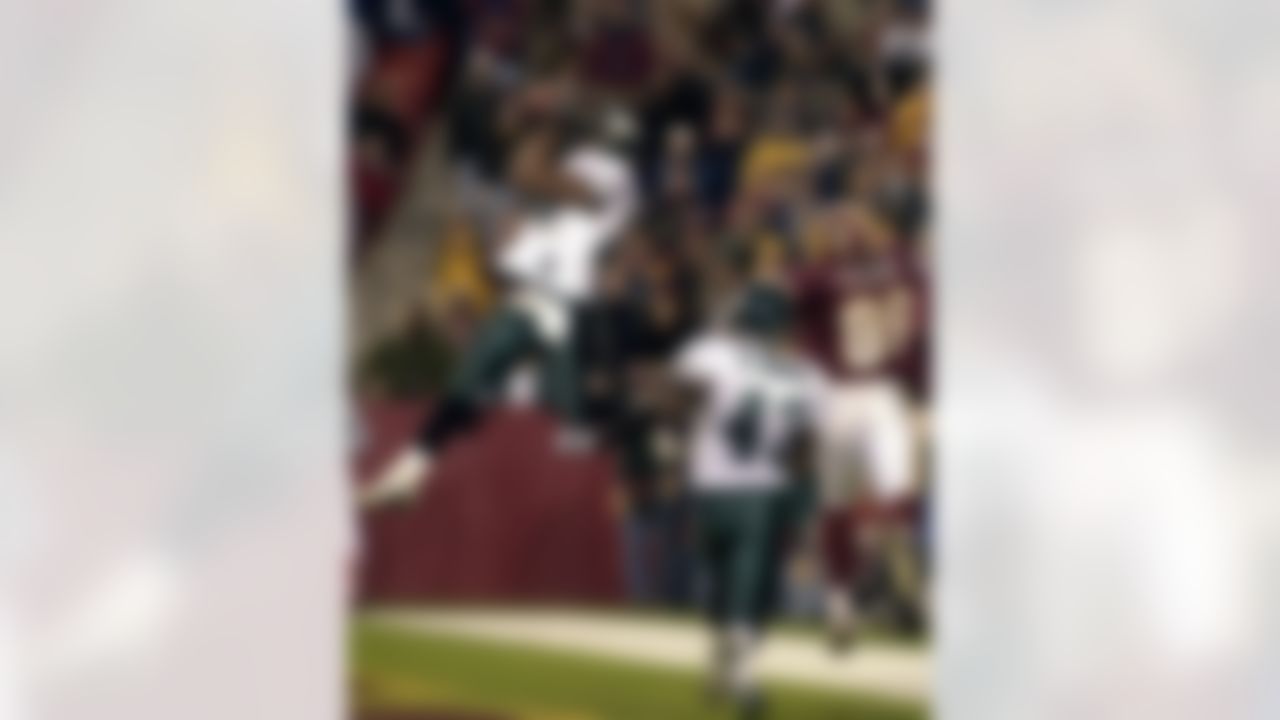 Philadelphia Eagles' Brian Dawkins, left, intercepts a pass in the end zone in front of Washington Redskins' Zeron Flemister (89) and Eagles' Famon Moore (43) during the fourth quarter Sunday, Dec. 16, 2001, at FedX Field in Landover, Md. The Eagles won 20-6. (AP Photo/Stephen J. Boitano)