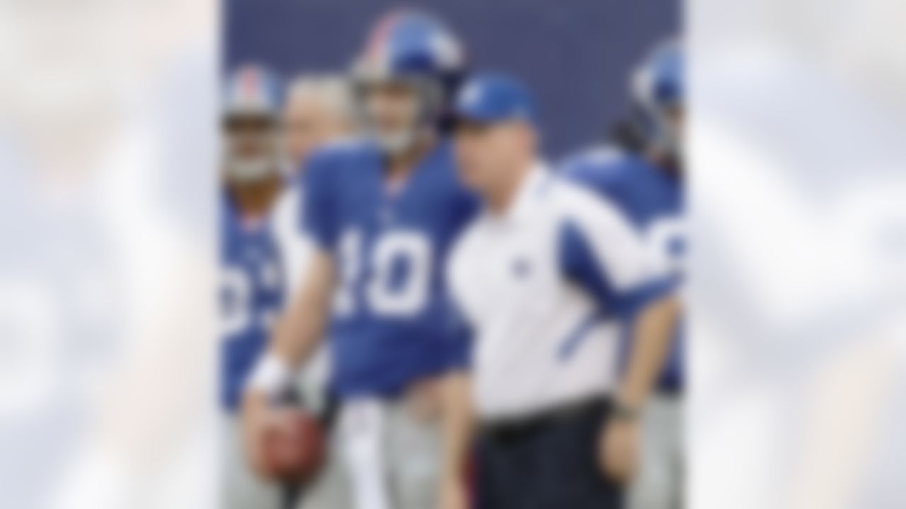 New York Giants quarterback Eli Manning (10) talks with coach Tom Coughlin during warmups before the Giants faced the New England Patriots in an NFL preseason football game at Giants Stadium in East Rutherford, N.J. (AP Photo/Kathy Willens)