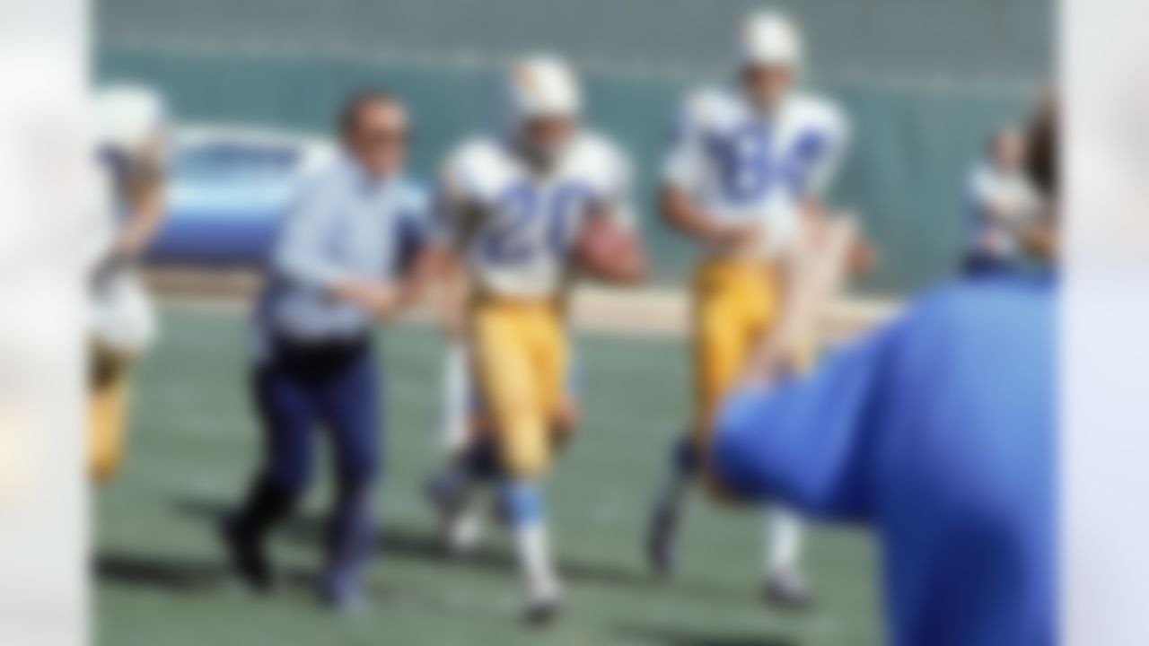 SAN DIEGO, CA - SEPTEMBER 19: Head coach Sid Gilman of the San Diego Chargers congratulates running back Mike Garrett #20 after he scored against the Kansas City Chiefs at San Diego Stadium on September 19, 1971 in San Diego, California. The Chargers defeated the Chiefs 21-14. (Photo by NFL Photos/Getty Images)