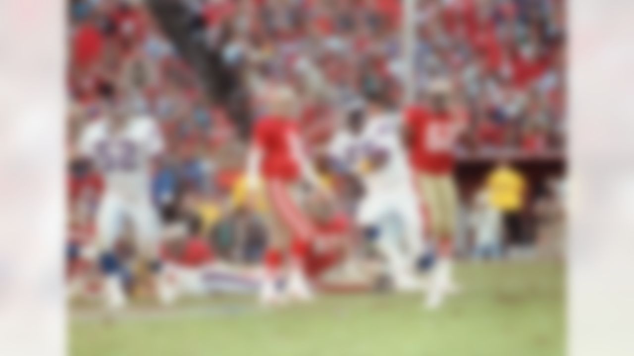 New York Giants linebacker Lawrence Taylor runs after recovering a 49ers fumble in the fourth quarter of the NFC championship game to help win the game 15-13 in San Francisco on Jan. 20, 1991. 49ers in photo are quarterback Steve Young (8), Jesse Sapolu (61), and Guy McIntyre (62). (AP Photo/Rich Pedroncelli)