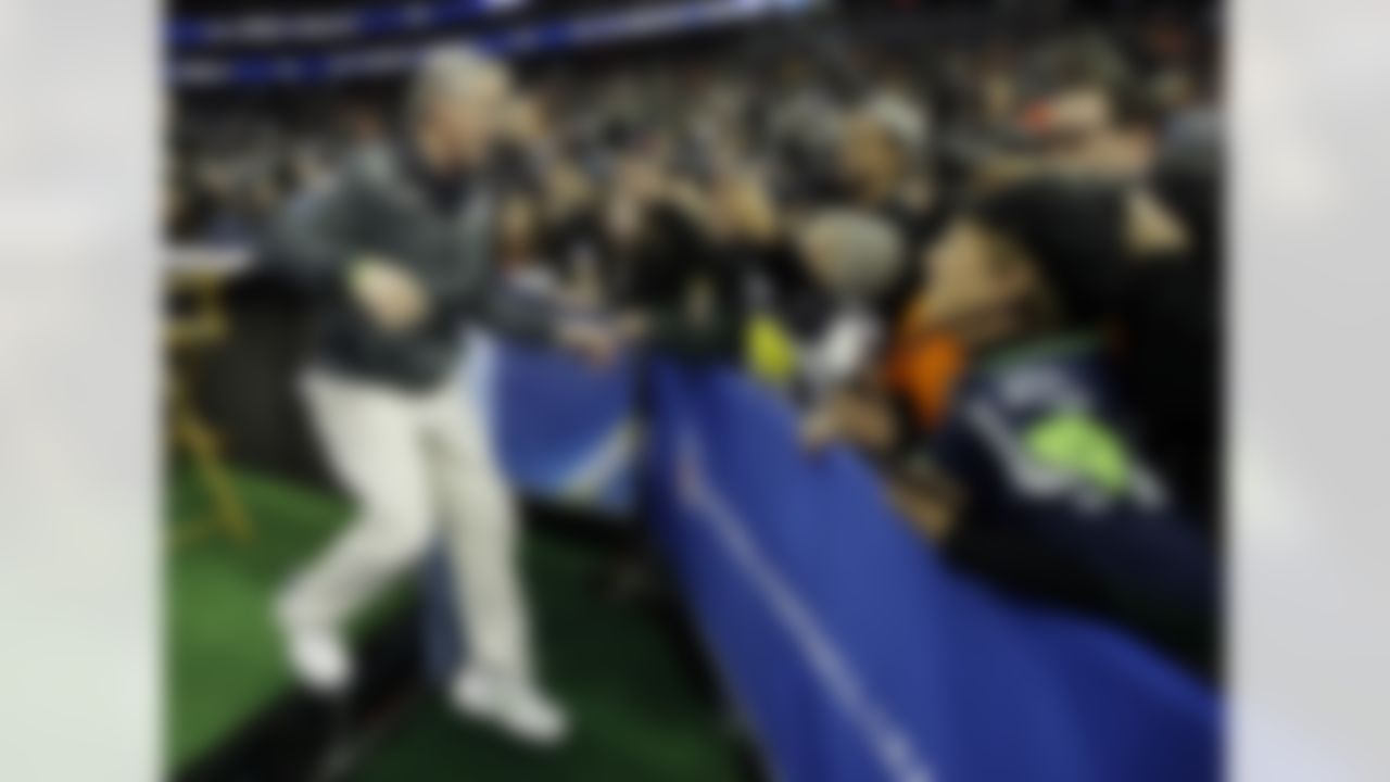 Seattle Seahawks head coach Pete Carroll goes to hug Teresa Dahlquist during media day for the NFL Super Bowl XLVIII football game Tuesday, Jan. 28, 2014, in Newark, N.J. (AP Photo/Matt Slocum)