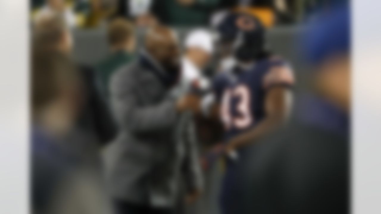 Deion Sanders talks to Chicago Bears running back Joique Bell (43) before an NFL football game, Thursday, Oct. 20, 2016, in Green Bay, Wis. (AP Photo/Matt Ludtke)
