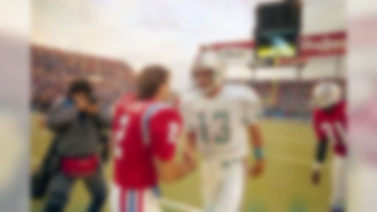 New England Patriots quarterback Doug Flutie greets Miami Dolphins quarterback Dan Marino as he heads to the locker room following their game in Foxboro, Mass, Nov. 7, 1988. The Patriots won, 21-10. (AP Photo/Jim Gerberich)