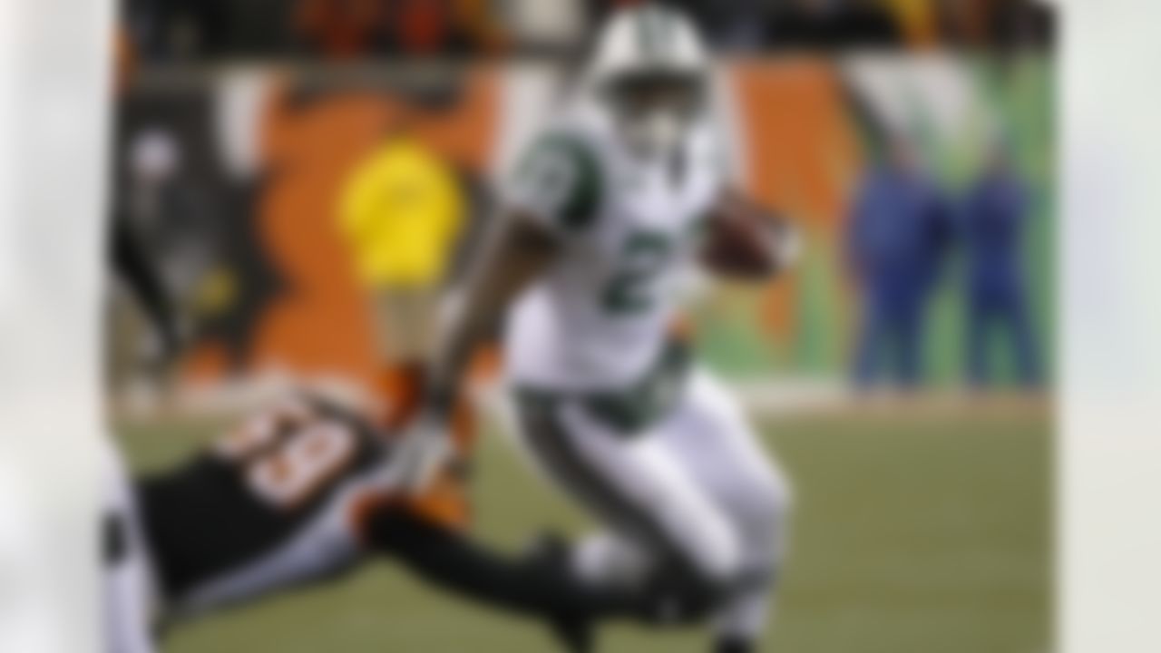 New York Jets running back Shonn Greene runs the ball past Cincinnati Bengals linebacker Brandon Johnson during the second half of an NFL wild-card playoff football game, Saturday, Jan. 9, 2010, in Cincinnati. (AP Photo/Ed Reinke)
