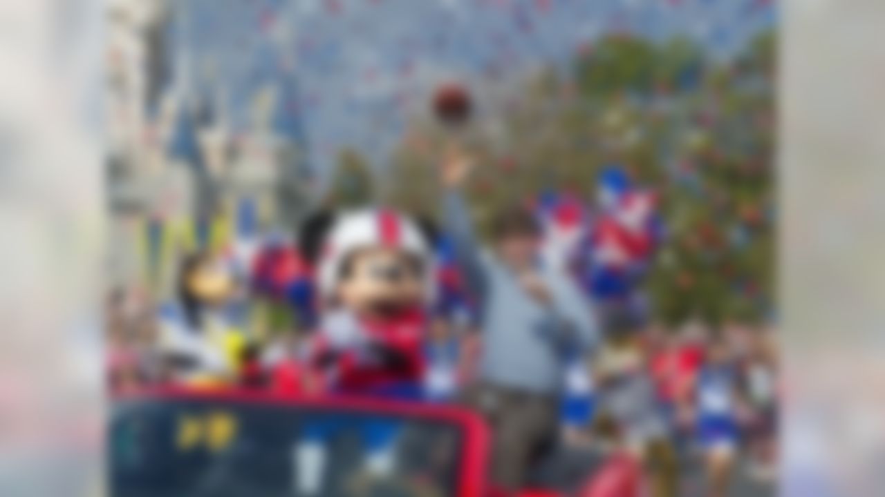 Super Bowl XLVI MVP and New York Giants quarterback Eli Manning throws a pass as he takes a celebratory ride with Mickey Mouse Monday Feb. 6, 2012 at the Magic Kingdom at Walt Disney World Resort in Lake Buena Vista, Fla. The celebration at the theme park took place only one day after Manning led his team to a 21-17 victory over the New England Patriots in Super Bowl XLVI in Indianapolis. Immediately following the game, Manning looked into TV cameras and shouted "I'm Going to Disney World!" He is the latest star in the famous Disney commercial series. (AP Photo/Disney, Gene Duncan)
