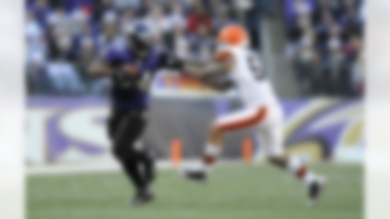 Baltimore Ravens running back Ricky Williams, left, tries to push away Cleveland Browns outside linebacker Kaluka Maiava as he rushes the ball in the second half of an NFL football game in Baltimore, Saturday, Dec. 24, 2011. (AP Photo/Nick Wass)