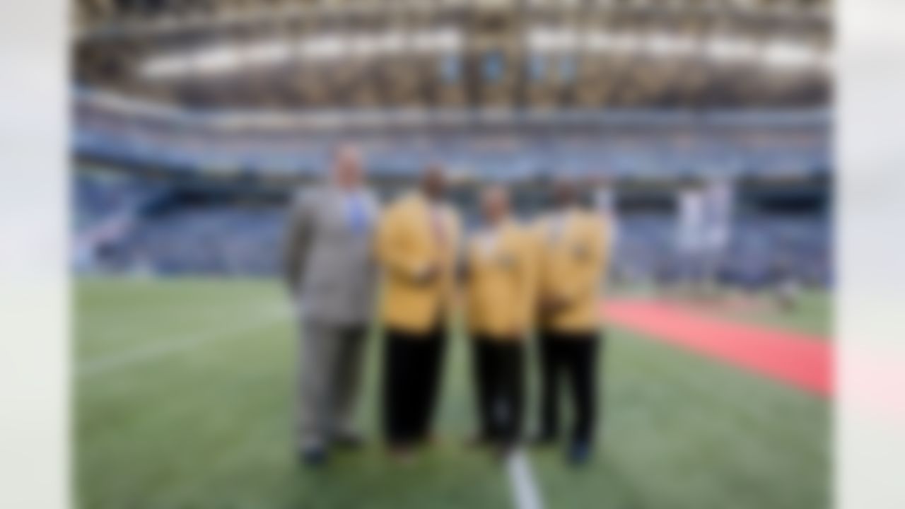 Pro Football Hall of Fame President and Executive Director David Baker, left, stands with former Seattle Seahawks and Pro Football Hall-of-Fame members (left to right) Walter Jones, Steve Largent, and Cortez Kennedy following a halftime ceremony during an NFL football game between the Seattle Seahawks and the Green Bay Packers Thursday, Sept. 4, 2014, in Seattle. (AP Photo/Scott Eklund)