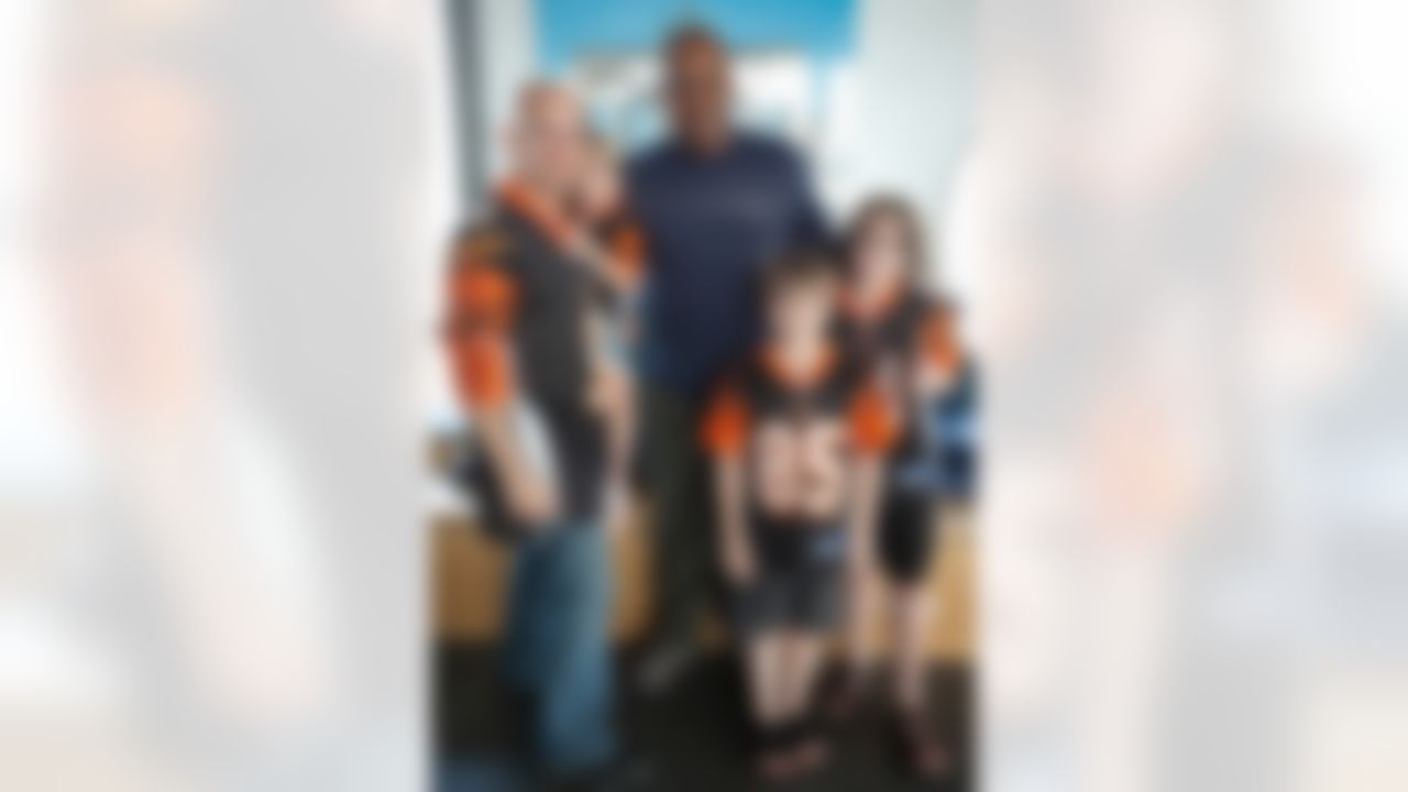 Cincinnati Bengals head coach Marvin Lewis poses for a photo with a family of Cincinnati Bengals fans at the USO Center in the Ramstein Passenger Terminal at Ramstein Air Base in Germany, June 29, 2010. The National Football League (NFL) deployed Lewis and three of its other most sought-after coaches to Germany and the Persian Gulf to visit troops as part of a week-long USO/Armed Forces Entertainment tour. (Fred Greaves/USO)