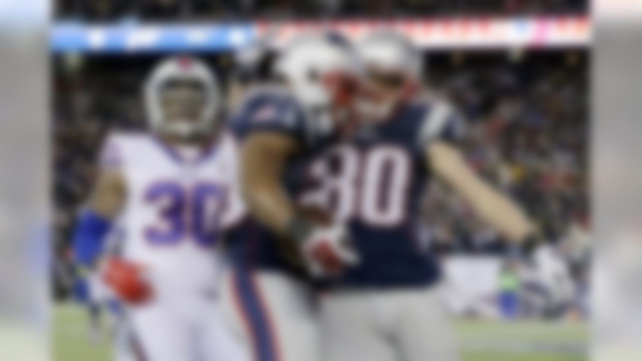 New England Patriots running back James White, center, celebrates his touchdown with wide receiver Danny Amendola (80) in front of Buffalo Bills safety Bacarri Rambo (30) in the first half of an NFL football game, Monday, Nov. 23, 2015, in Foxborough, Mass. (AP Photo/Charles Krupa)