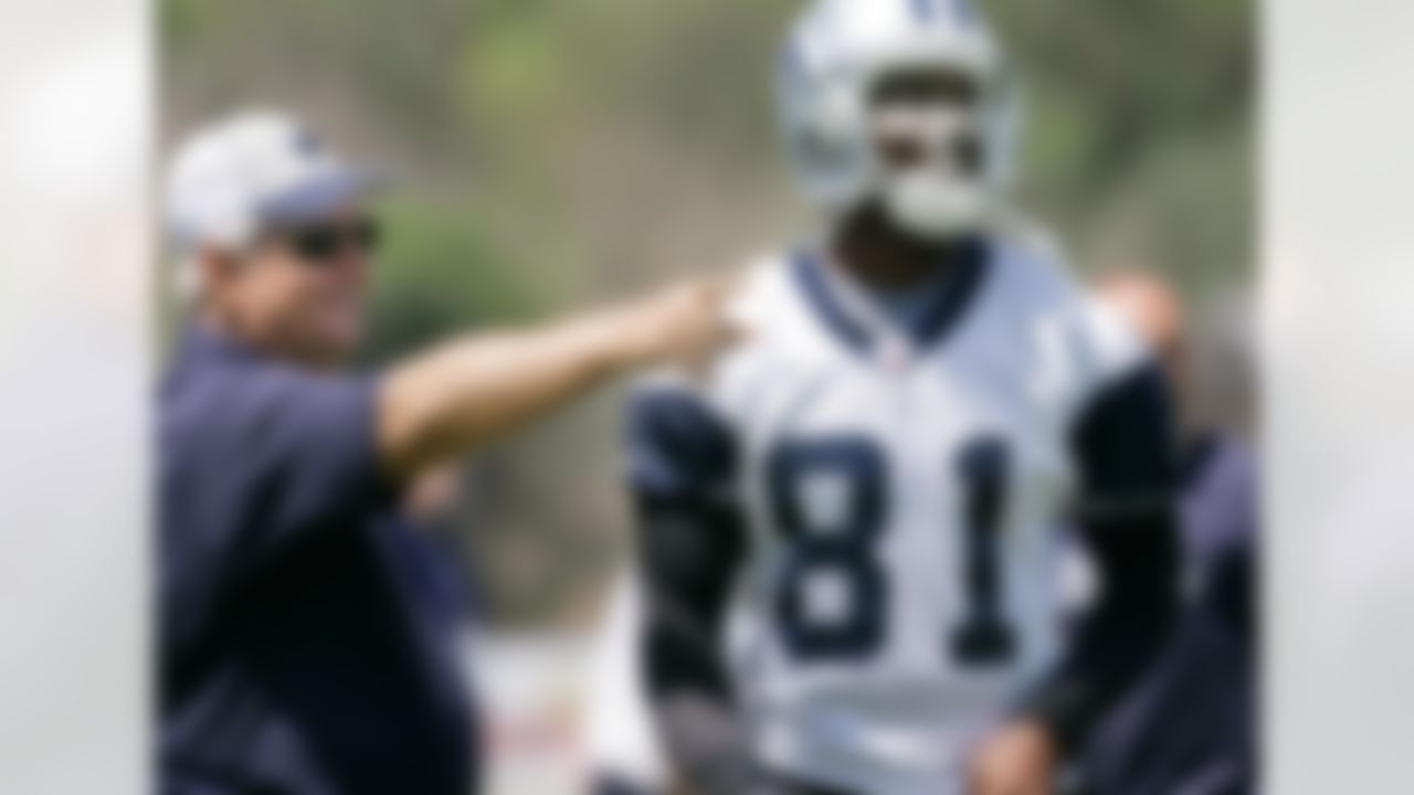 Dallas Cowboys head coach Wade Phillips, left, smiles as he points someone out to wide receiver Terrell Owens (81) prior to the start of the teams first football training camp practice, Friday, July 25, 2008, in Oxnard, Calif. (AP Photo/Tony Gutierrez)