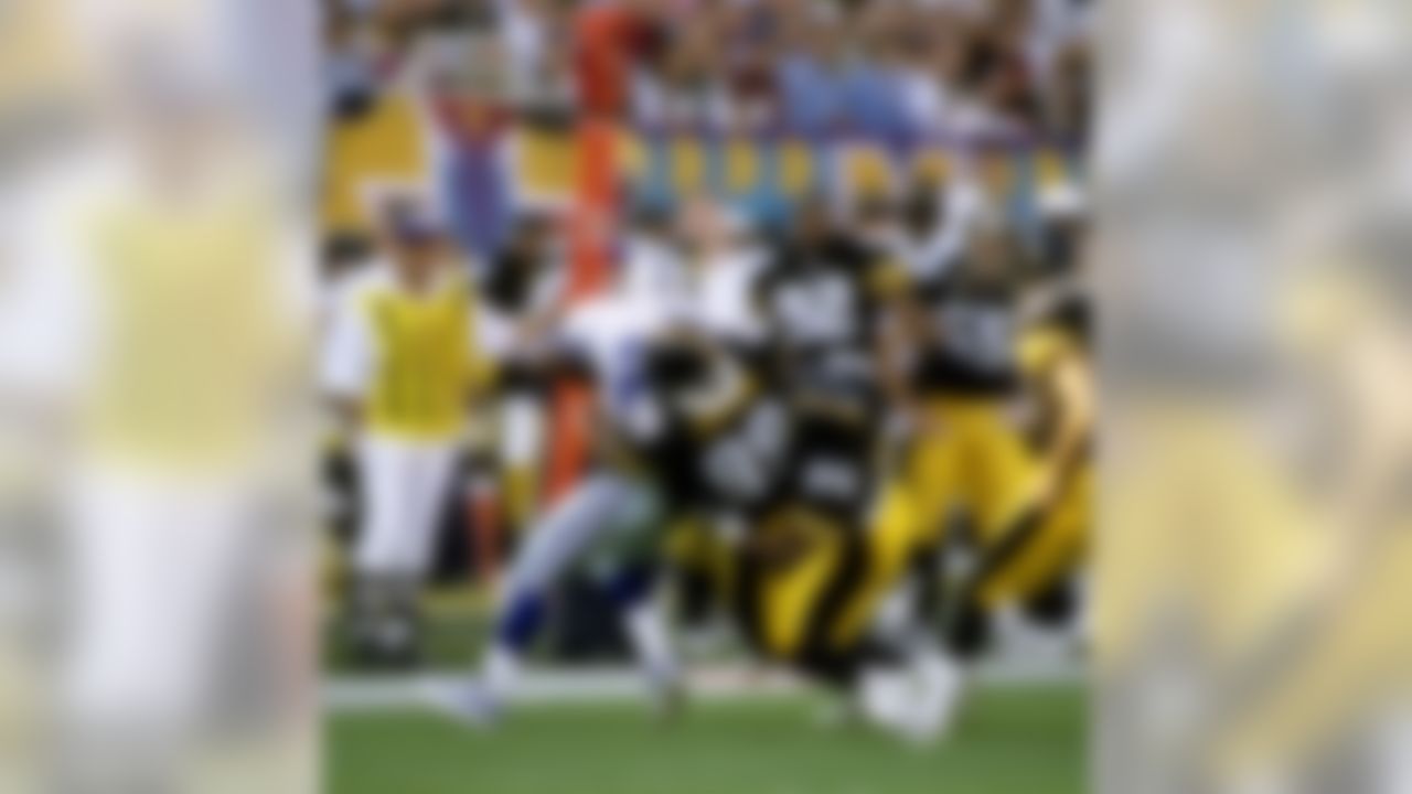 Pittsburgh Steelers linebackers Levon Kirkland (99) and Greg Lloyd (95) gang up to bring down Dallas Cowboys running back Emmitt Smith (22) during Super Bowl XXX at Sun Devil Stadium in Tempe, AZ on January 28, 1996. (National Football League)