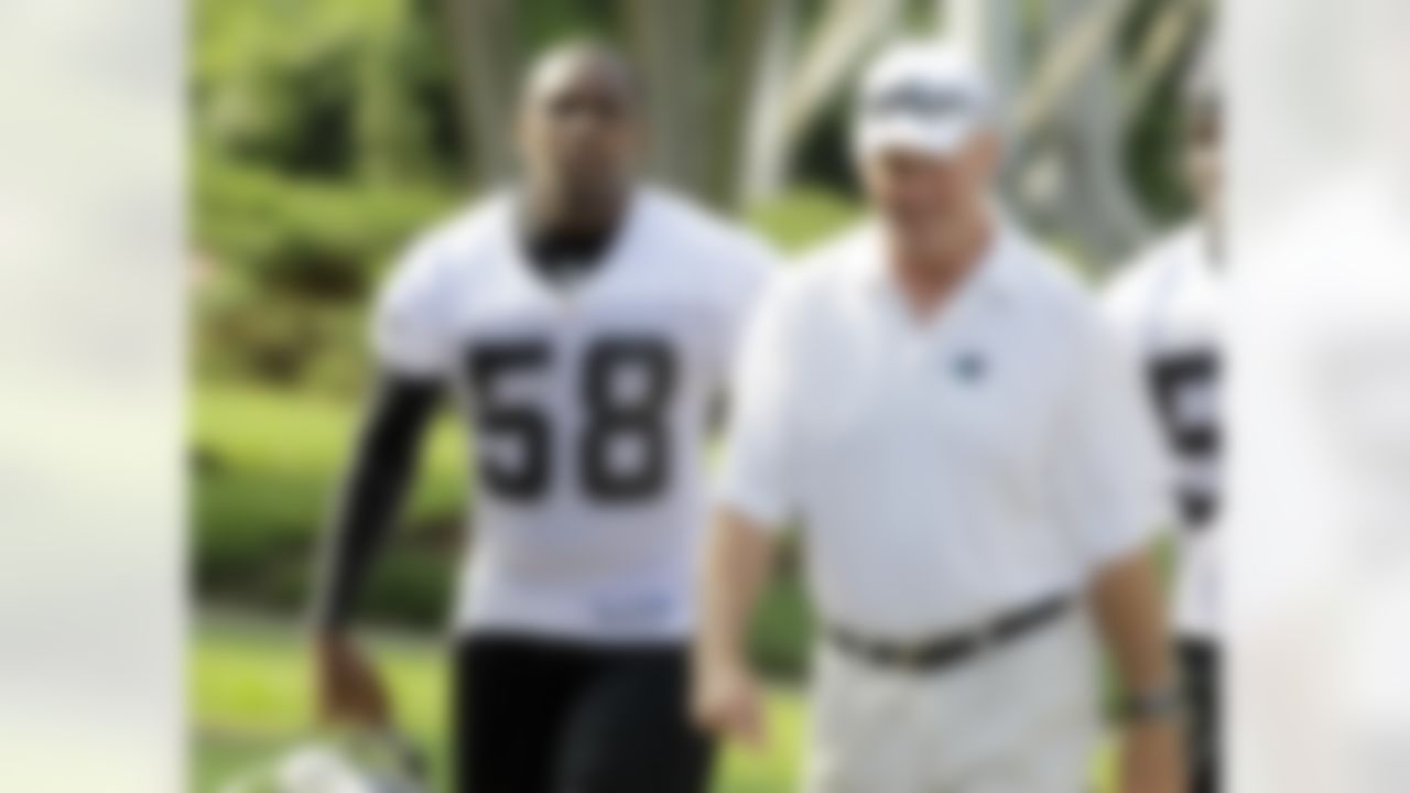 In this photo taken on Wednesday, June 2, 2010, Carolina Panthers' Thomas Davis (58) walks with head coach John Fox, right, before a voluntary football workout in Charlotte, N.C. (AP Photo/Chuck Burton)