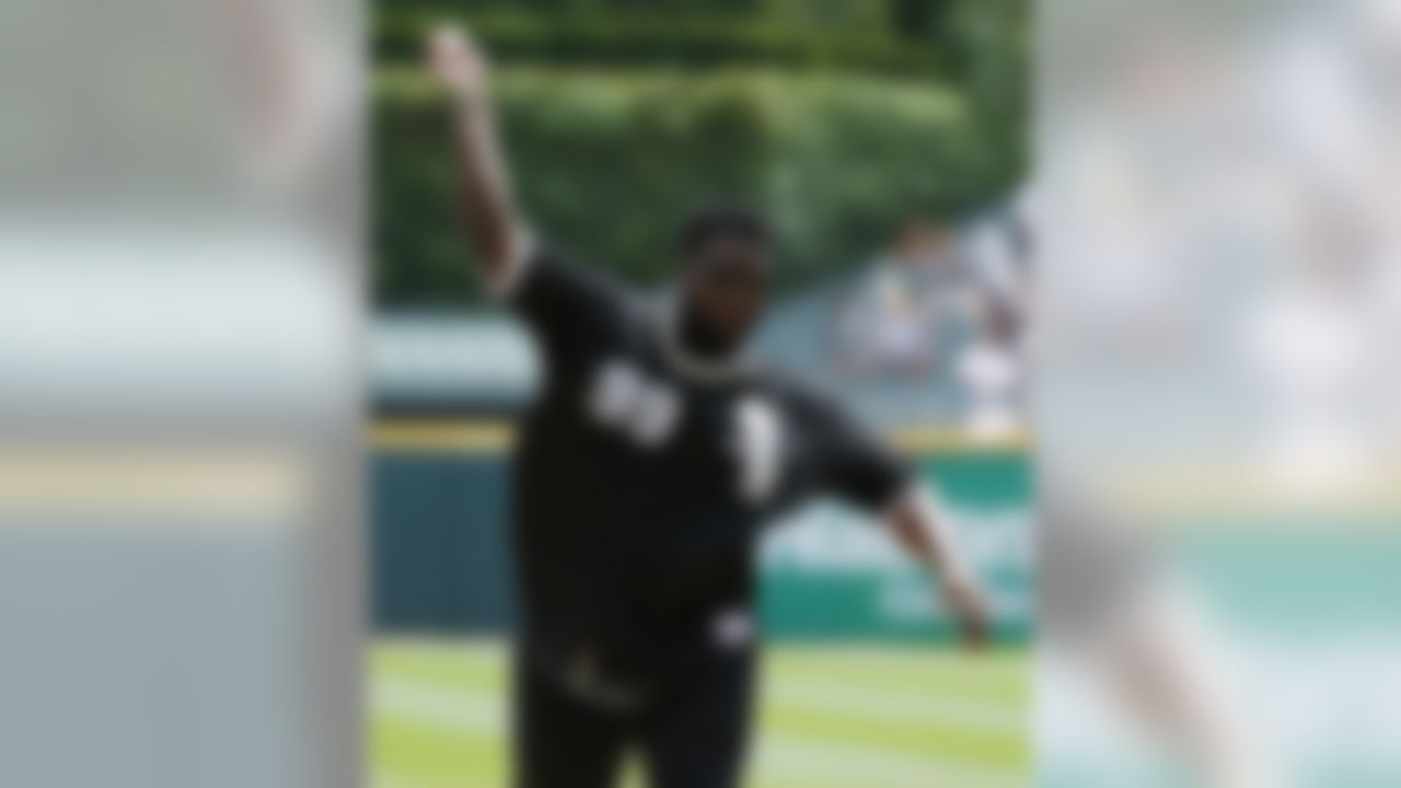 Carolina Panthers defensive tackle Kawann Short throws out a ceremonial first pitch before an interleague baseball game between the Atlanta Braves and the Chicago White Sox in Chicago, Sunday, July 10, 2016. (AP Photo/Nam Y. Huh)