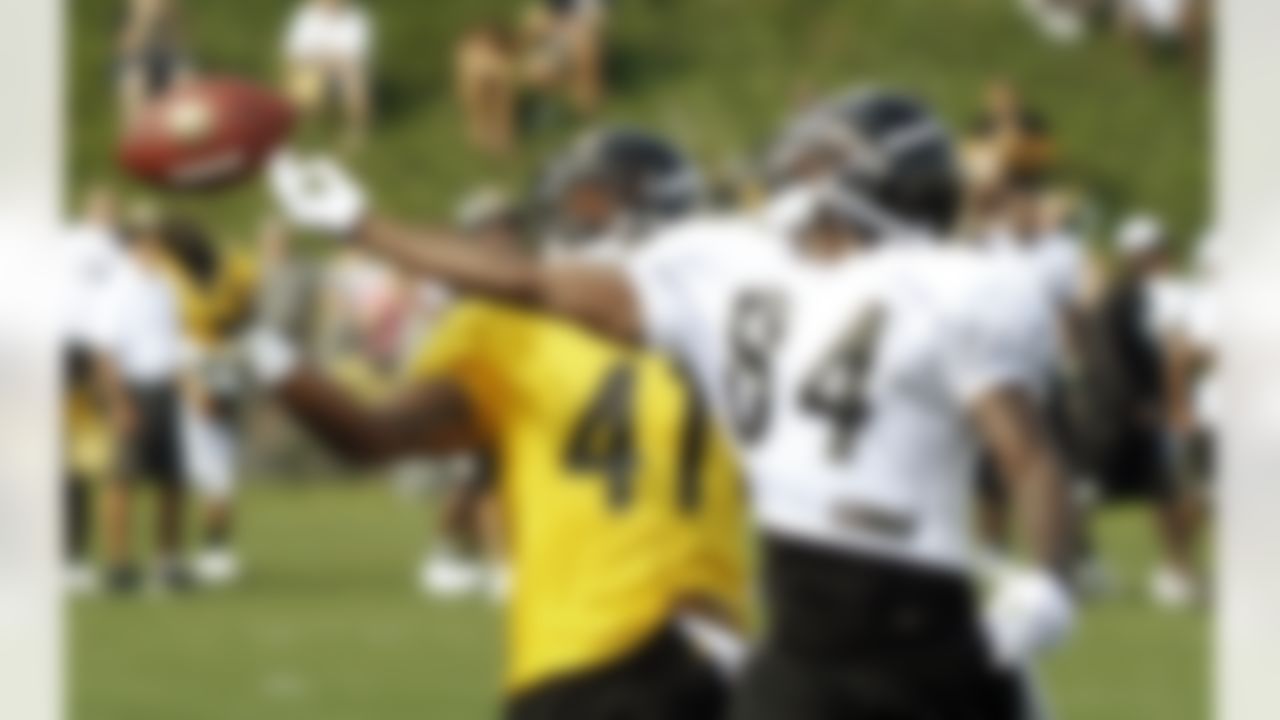Pittsburgh Steelers wide receiver Antonio Brown (84) reaches for and misses a pass as defensive back Andre Freeman (41) defends during practice at the NFL football training camp in Latrobe, Pa., Sunday, July 29, 2012. (AP Photo/Keith Srakocic)