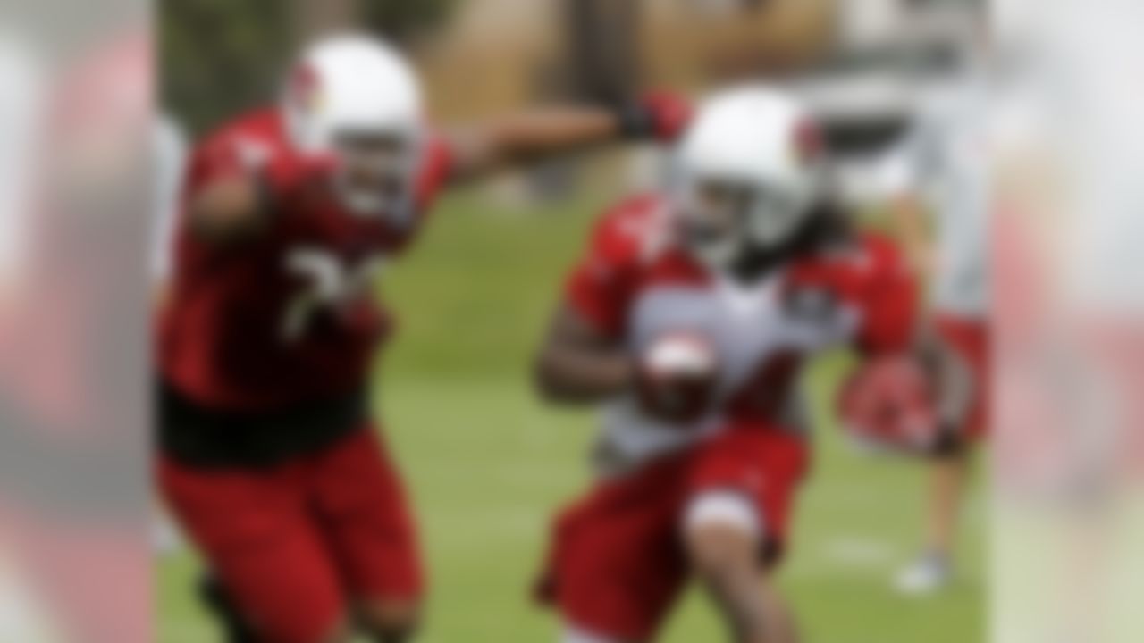 Arizona Cardinals' Ryan Williams (34) gets past Jeremy Bridges (73) during running drills on the first day of practice during the NFL football team's training camp at Northern Arizona University, Wednesday, July 25, 2012, in Flagstaff, Ariz. (AP Photo/Ross D. Franklin)
