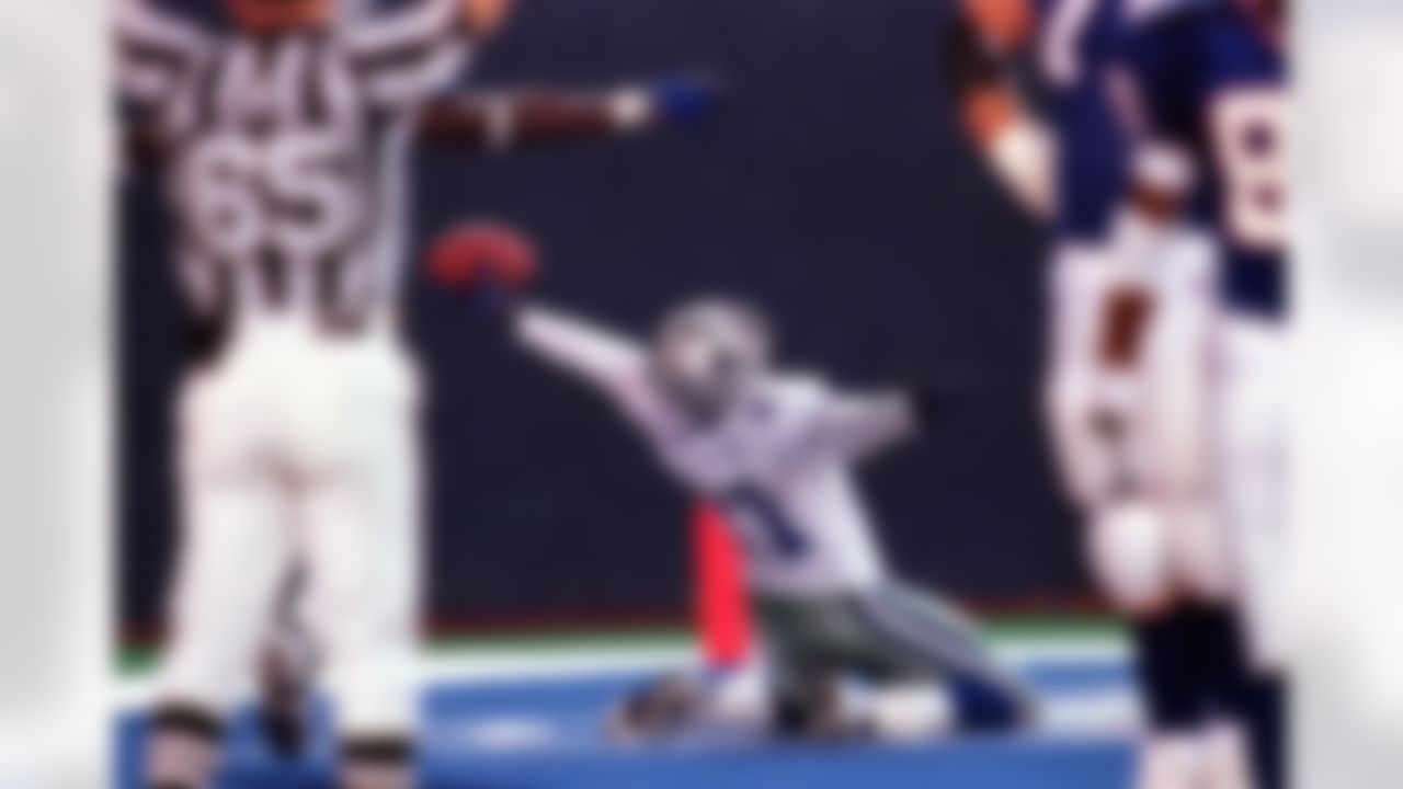 FILE - This Sept. 21, 1998, file photo shows Dallas Cowboys' Deion Sanders celebrating after intercepting a pass from New York Giants quarterback Danny Kanell and returning 71-yards for a touchdown during the fourth quarter, at Giants Stadium in East Rutherford, N.J. Dallas Cowboys' Marc Colombo flubbed the landing on a chest bump following a touchdown last weekend. What started as a harmless stunt ended up leading to a loss and reopening the discussion about whether the NFL goes too far trying to stamp out showboating. (AP Photo/Bill Kostroun, File)