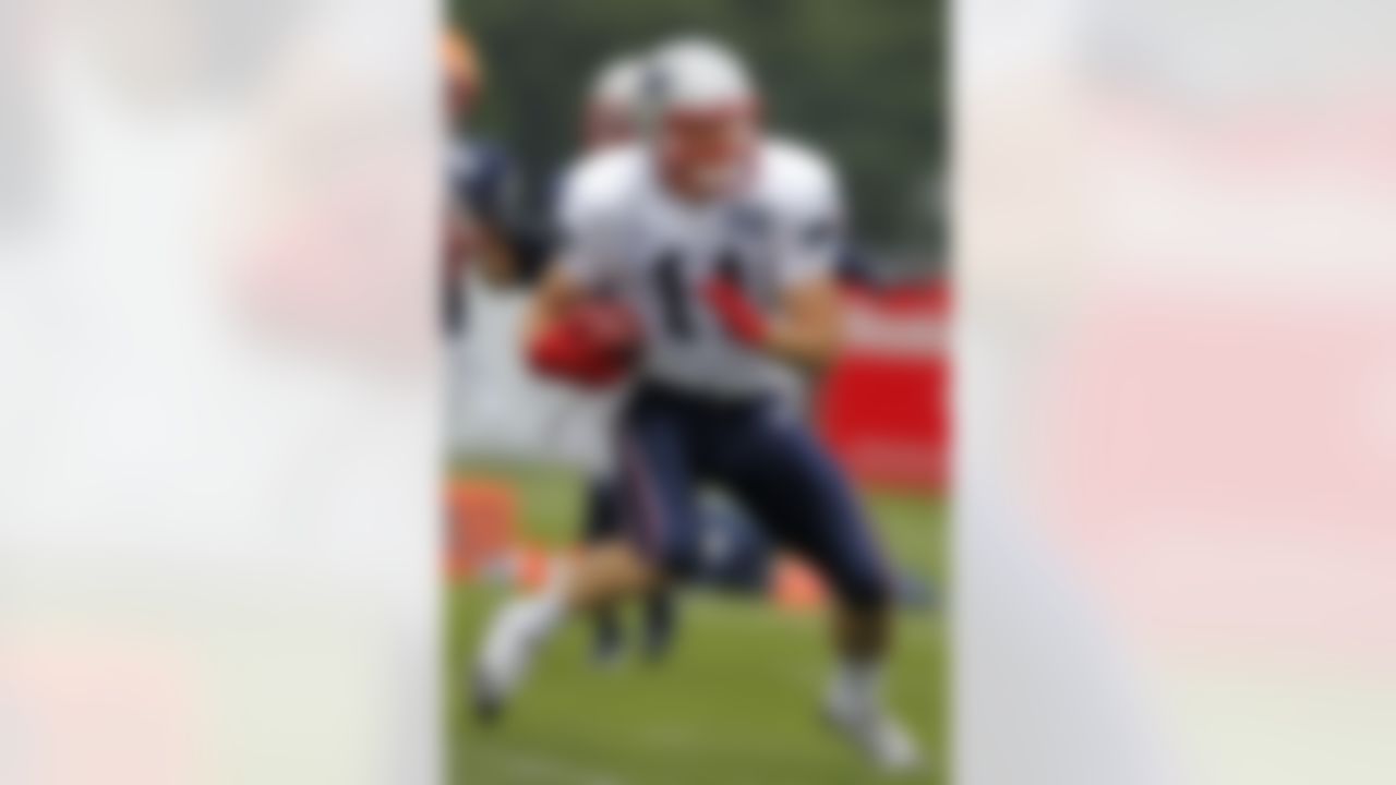 New England Patriots wide receiver Julian Edelman (11) runs with the ball during an NFL football training camp in Foxborough, Mass., Sunday, July 29, 2012. (AP Photo/Steven Senne)