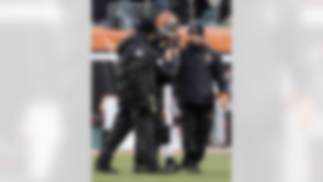 Cincinnati Bengals linebacker Rashad Jeanty, center, is helped off the field after getting injured against the New York Jets during the first half of an NFL wild-card playoff football game, Saturday, Jan. 9, 2010, in Cincinnati. Jeanty broke his left leg on the opening kickoff of the game. (AP Photo/Rob Carr)