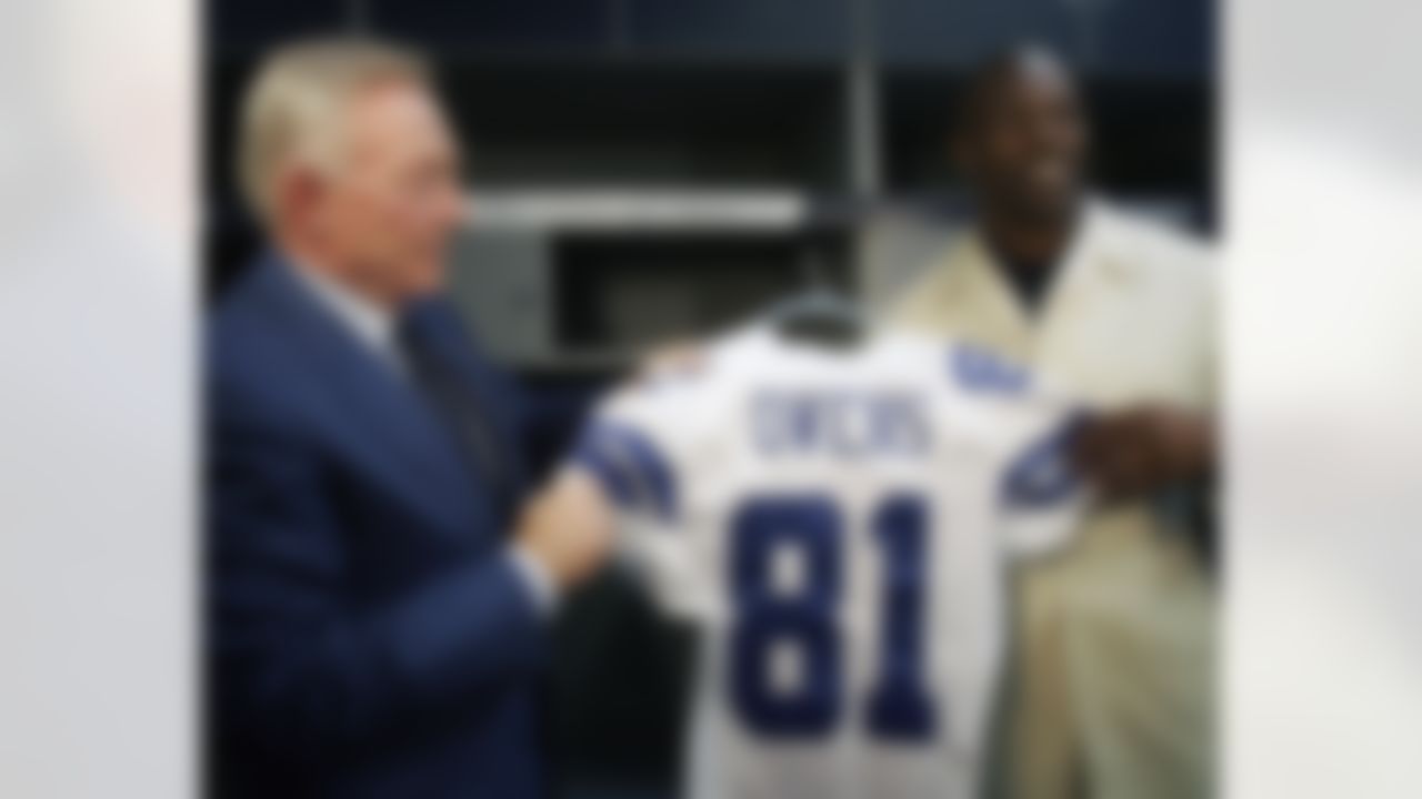 Dallas Cowboys football team owner Jerry Jones, left and Terr Owens pose with a jersey in the team locker room in Irving, Texas, Saturday, March 18, 2006. Owens signed a three-year contract with the NFL team. (AP Photo/Ron Heflin)