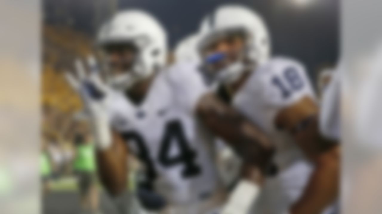 Penn State wide receiver Juwan Johnson, left, is congratulated by teammate Jonathan Holland after catching a touchdown pass as time expired to defeat Iowa in an NCAA college football game Saturday, Sept. 23, 2017, in Iowa City, Iowa. (AP Photo/Jeff Roberson)