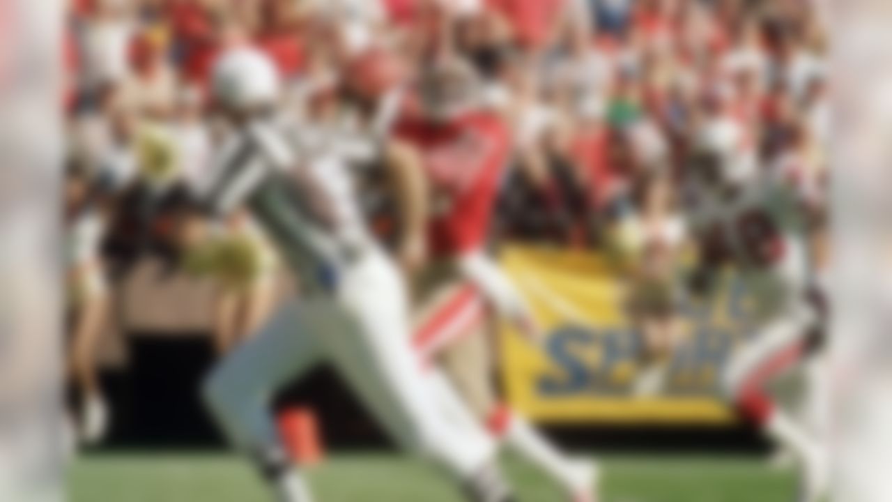 San Francisco 49ers wide receiver Jerry Rice (80) pulls in a touchdown pass from quarterback Steve Young (not shows) as Los Angeles Rams safety Nolan Cromwell tries unsuccessfully to prevent the score in the first quarter of game on Sunday, Dec. 27, 1987 in San Francisco. With the catch, Rice extended his NFL record for touchdown catches in consecutive games to 13. (AP Photo/Dan Murphy)