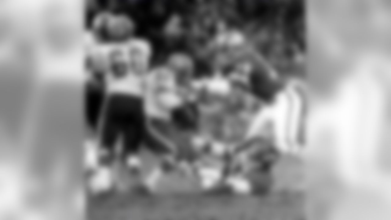 Hall of Fame linebackers Bobby Bell (78) and Willie Lanier (63) of the Kansas City Chiefs tackle Broncos running back Floyd Little in a 34 to 2 win over the Denver Broncos on September 22, 1968 at Municipal Stadium in Kansas City, Missouri. (Rod Hanna/NFL)
