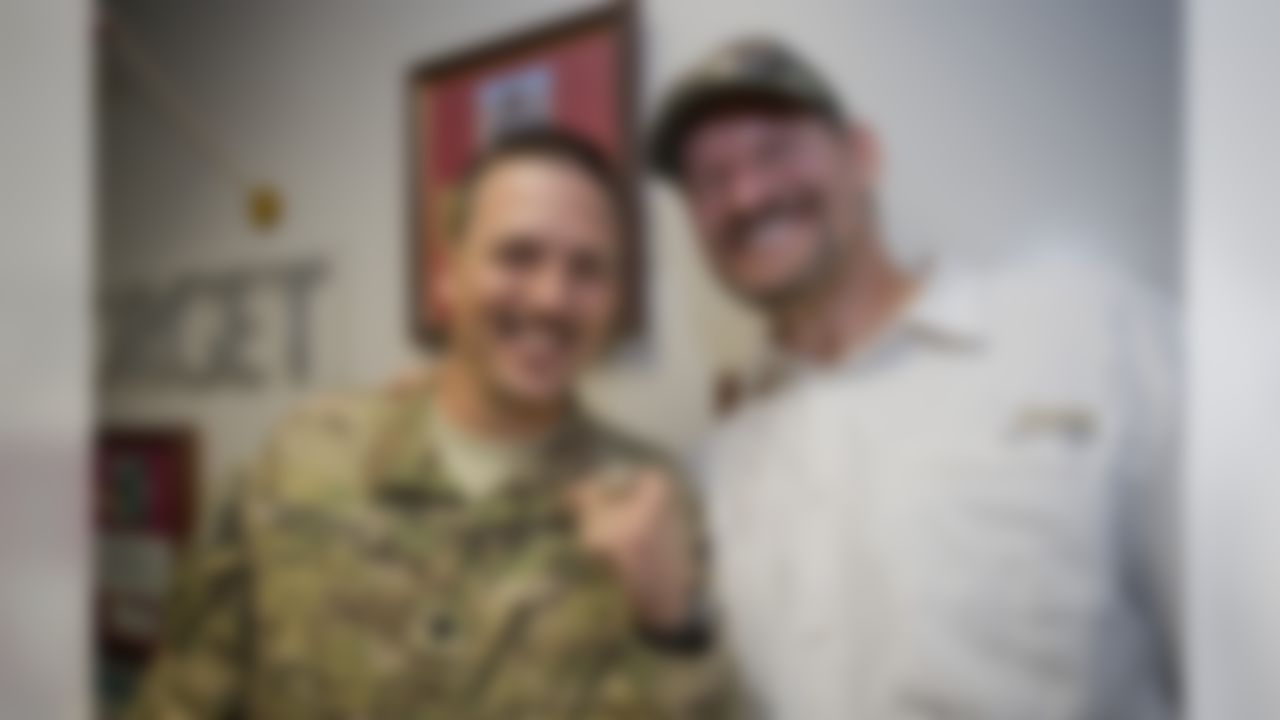 Former Pittsburgh Steelers head coach Bill Cowher, lets a fan, Mjr. McKissock - at the Craig Joint Theater Hospital, sport his Super Bowl ring, July 2, 2012. Cowher is joined by fellow NFL Coaches Leslie Frazier, Ben Kotwica and Eric Mangini for the weeklong adventure.  (Dave Gatley/USO)