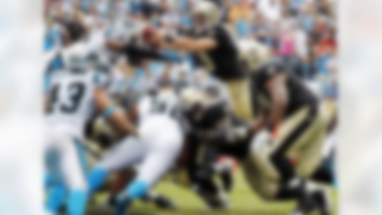 New Orleans Saints' Drew Brees (9) reaches the ball over the goal line for a touchdown against the Carolina Panthers during the fourth quarter of an NFL football game in Charlotte, N.C., Sunday, Sept. 16, 2012. The Panthers won 35-27. (AP Photo/Bob Leverone)