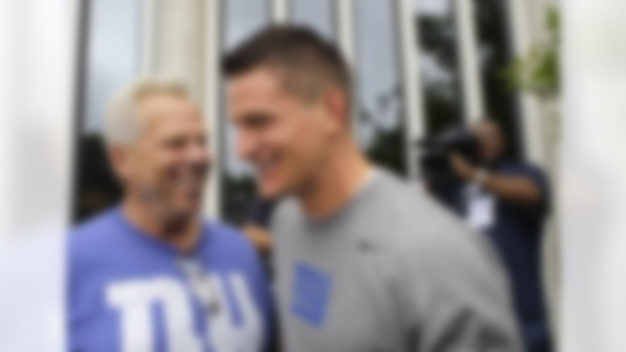 New York Giants co-owner Steve Tisch, left, and Giants punter Steve Weatherford share a laugh at the Giants football training camp in Albany, N.Y., Friday, July 27, 2012. (AP Photo/Kathy Willens)