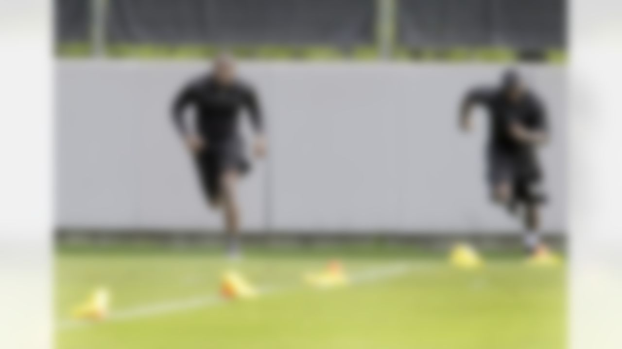 Carolina Panthers' Thomas Davis, left, runs sprints with teammate Jon Beason, right, during a voluntary football workout session in Charlotte, N.C., Wednesday, June 2, 2010. (AP Photo/Chuck Burton)
