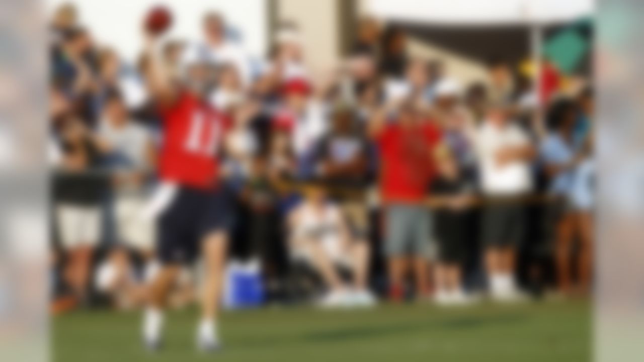 Tennessee titan quarterback Rusty Smith throws as fans watch during NFL football camp at Titans' headquarters Sunday, July 29, 2012 Nashville, Tenn. (AP Photo/Wade Payne)