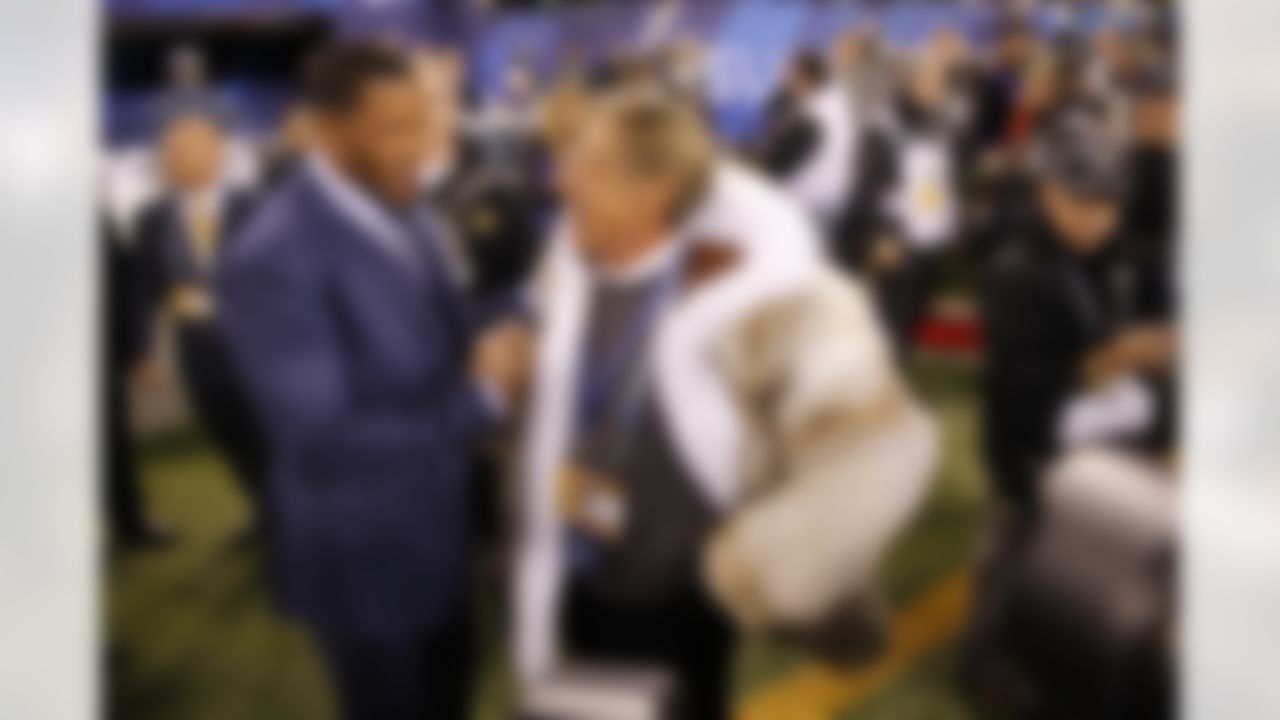 Former NFL players Joe Namath and Michael Strahan hug each other before Super Bowl XLVIII at Metlife Stadium on Sunday, Feb. 2, 2014, in East Rutherford, N.J. (Ben Liebenberg/NFL)